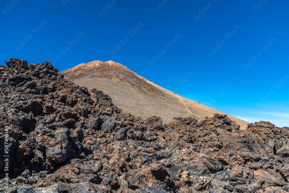 Peak of Teide Volcano  and lava around on sunny March day