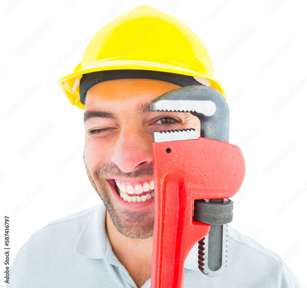 Obraz premium Cheerful handyman looking through monkey wrench