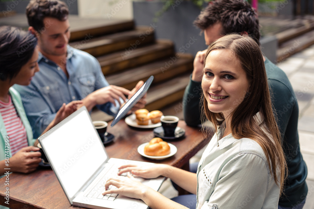Fototapeta premium Young woman sitting with colleagues 