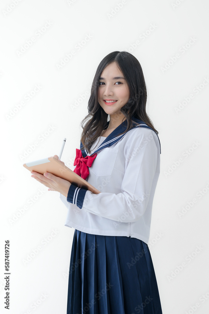 happy cheerful asian girl in japanese student uniform with tablet for online study on white background