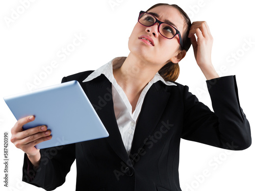 Thinking businesswoman looking at tablet pc