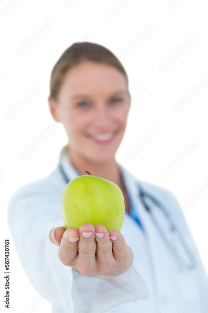 Smiling doctor offering an apple Smiling doctor offering an apple