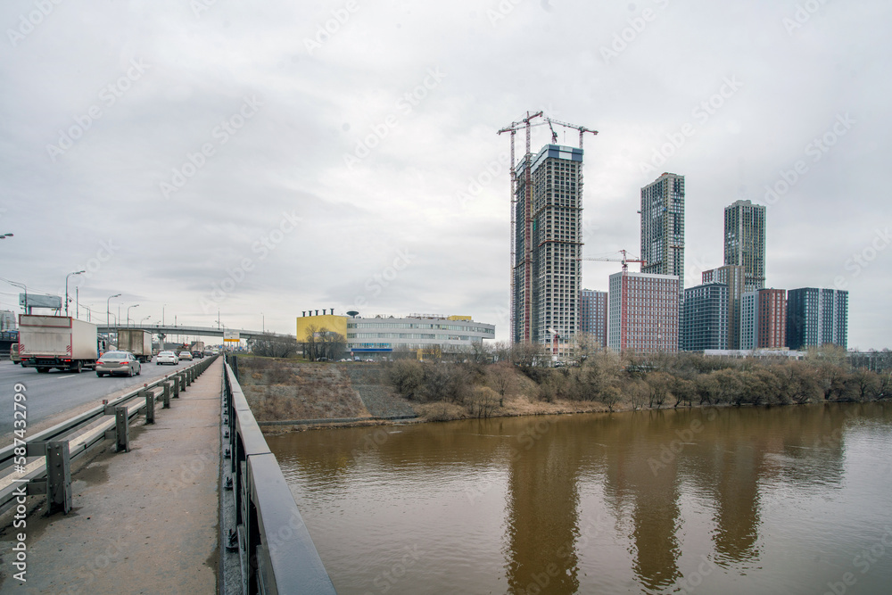 New residential buildings  in construction process in Trikotazanaya district of Moscow  and Moscow River
