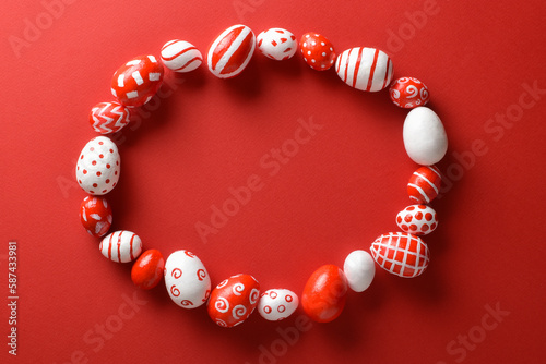 Easter backgrounds with a frame of Easter red and white eggs on a bright red background