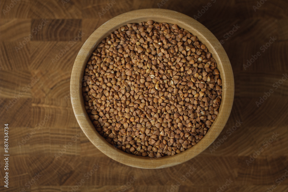 Buckwheat on a wooden board. Buckwheat on top. Buckwheat in a bowl. Cereals Buckwheat on a wooden board. Buckwheat on top. Buckwheat in a bowl. Cereals