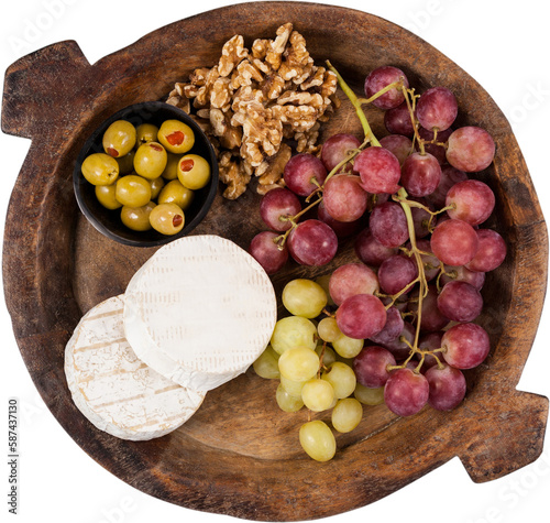 Grapes, walnut and olive on wooden bowl