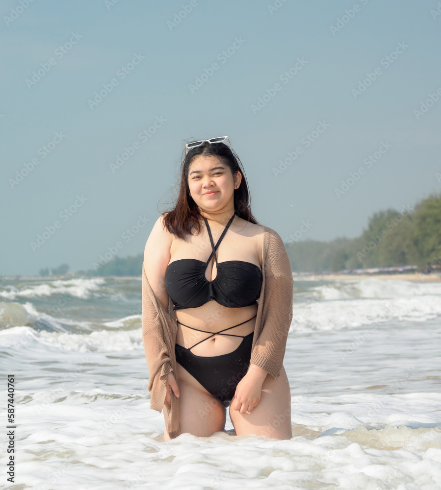 Portrait young woman asian chubby cute beautiful oneperson in bikini black  sexy front viewpoint tropical sea beach white sand clean and bluesky  background calm Nature ocean Beautiful wave water travel Stock Photo