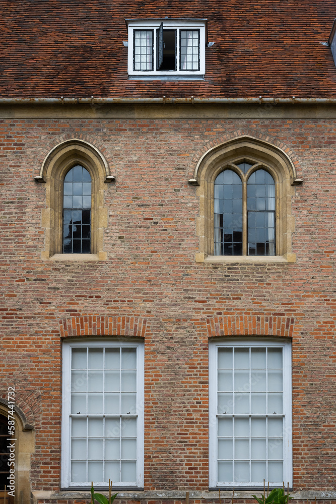Brick wall and old style windows architecture with arch at a college in Cambridge