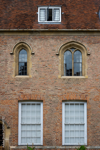 Brick wall and old style windows architecture with arch at a college in Cambridge