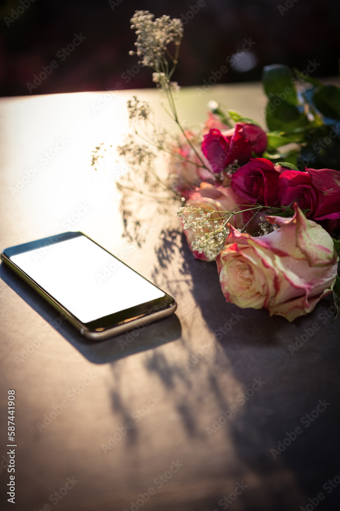 Obraz premium High angle view of mobile phone with flowers