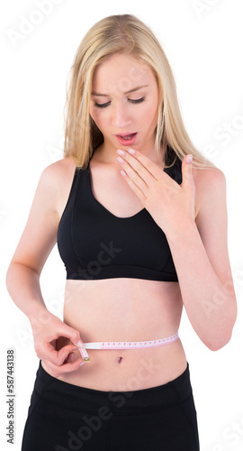 Fit young blonde looking at measuring tape