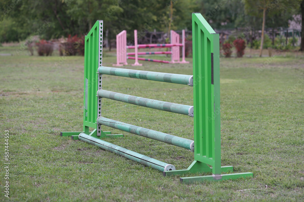 Horse obstacle course outdoors summertime. Poles in the sand at equestrian center outdoors Horse obstacle course outdoors summertime. Poles in the sand at equestrian center outdoors