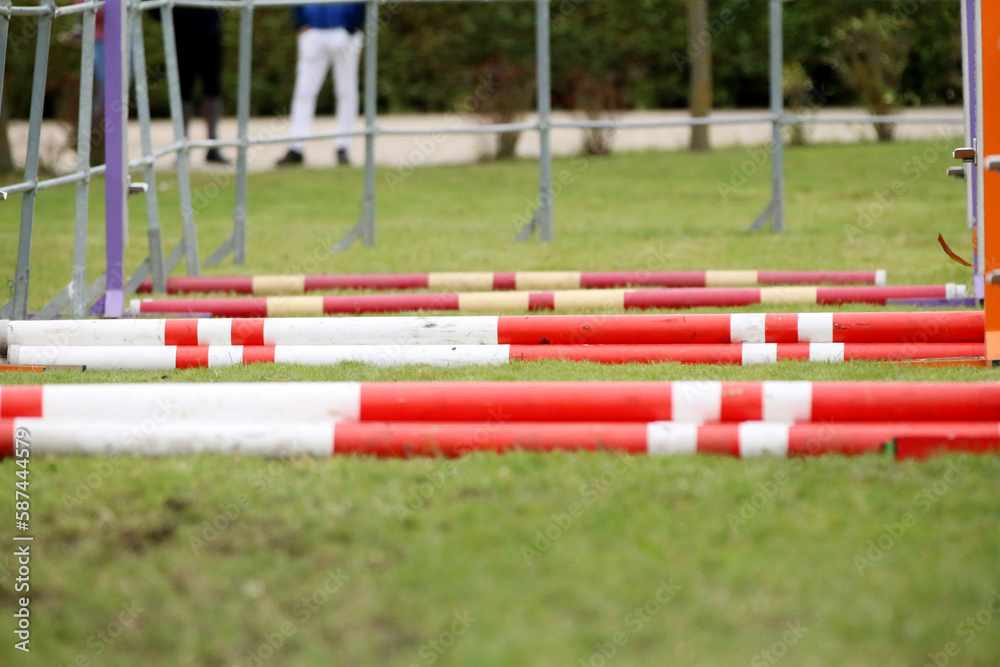 Horse obstacle course outdoors summertime. Poles in the sand at equestrian center outdoors Horse obstacle course outdoors summertime. Poles in the sand at equestrian center outdoors