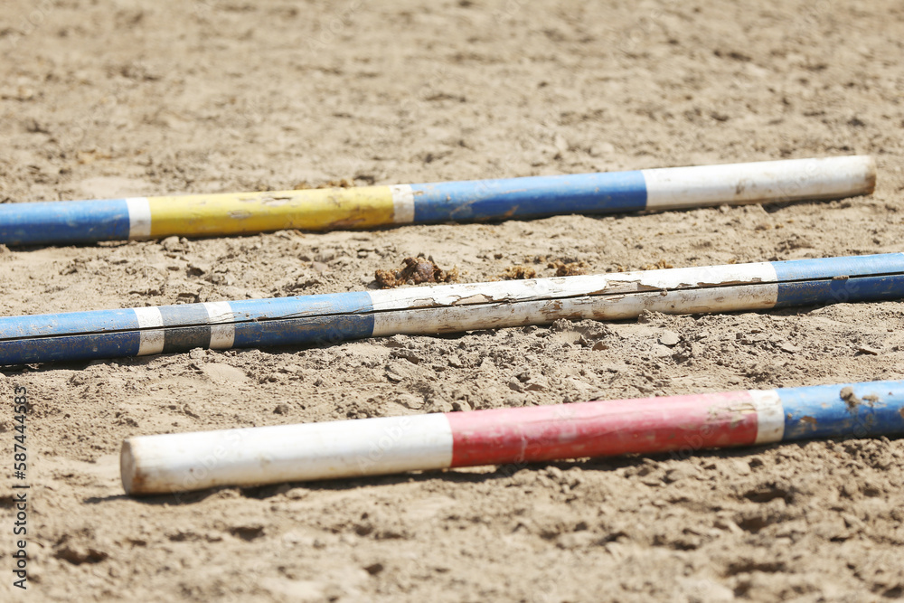 Horse obstacle course outdoors summertime. Poles in the sand at equestrian center outdoors Horse obstacle course outdoors summertime. Poles in the sand at equestrian center outdoors