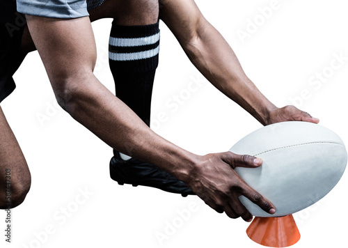 Cropped image of sportsman keeping rugby ball on kicking tee