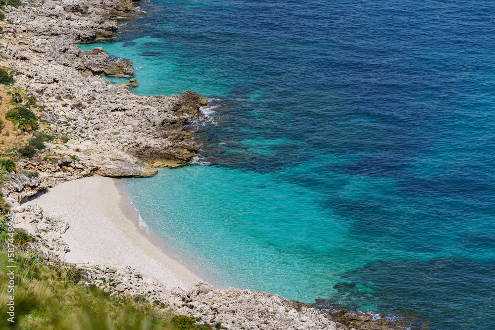 Beautiful stone beach flowing into the wonderful turquoise sea, seen from high mountains.