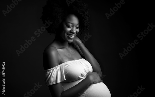 Beautiful black and white portrait of a young African-American pregnant woman, wearing a white dress and gently holding her belly with a smile on her face, created with generative A.I. technology.