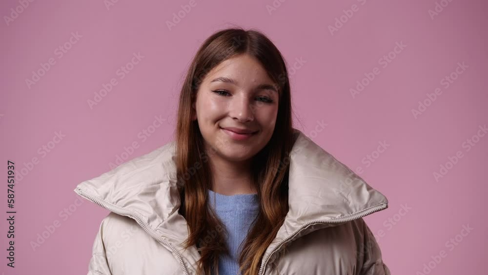 4k video of one girl is so excited about something over pink background. 4k video of one girl is so excited about something over pink background.