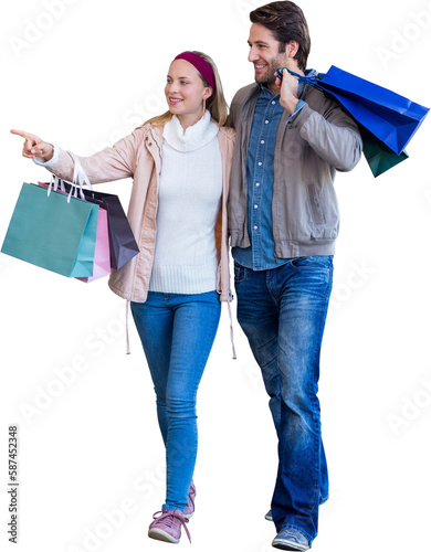 Smiling couple walking hand in hand and going window shopping