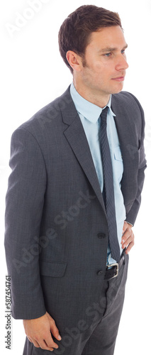 Serious businessman standing with hand on hip