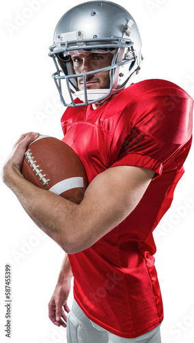Portrait of confident American football player in red jersey holding ball