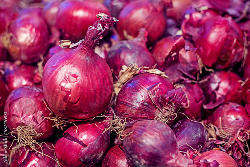 background of ripe red onions close-up. Organic onion top view. food background.