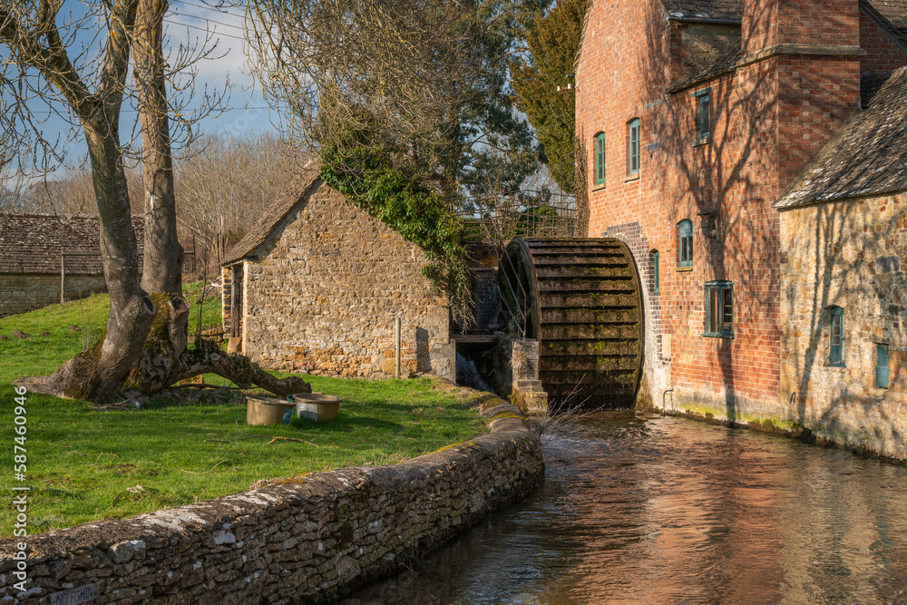 Iconic old mill next to River Eye in Lower Slaughter in Cotswolds England