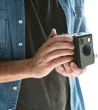 Mid section of photographer holding vintage camera 