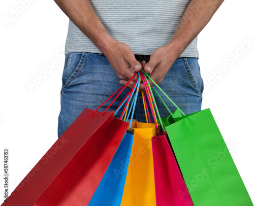 Midsection of man carrying colorful shopping bag against white background