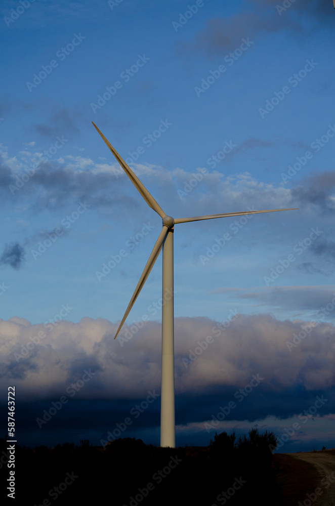 view of a stand-alone wind generator at sunset