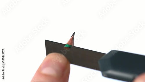 Sharpen a pencil with a carpet knife.