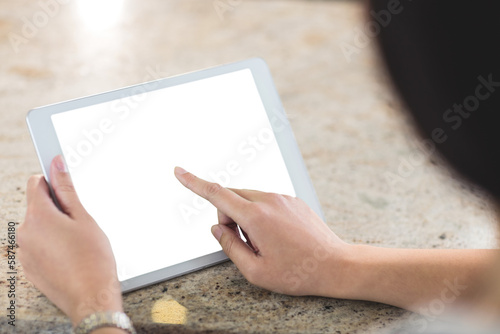 Cropped image of woman using tablet computer