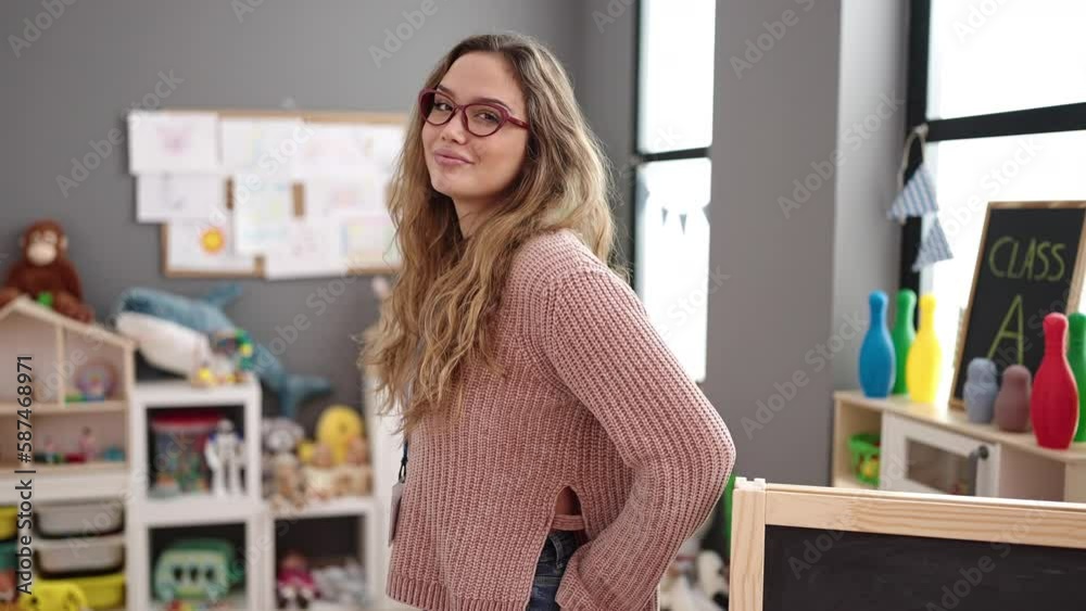 Young beautiful hispanic woman preschool teacher smiling confident standing at kindergarten Young beautiful hispanic woman preschool teacher smiling confident standing at kindergarten