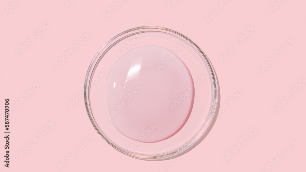 large drops of cosmetic serum, liquid, water, gel on a pink background large drops of cosmetic serum, liquid, water, gel on a pink background