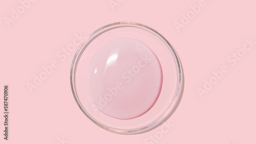 large drops of cosmetic serum, liquid, water, gel on a pink background