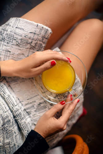 Young woman enjoying a cup of tea at cafe. Girl drinks hot tea. Teengirl drinking hot drink. Cafe city lifestyle. Cafe city lifestyle photo