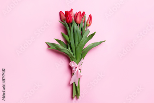 Bouquet of tulips on a pink background. With a pink bow © Marina Red