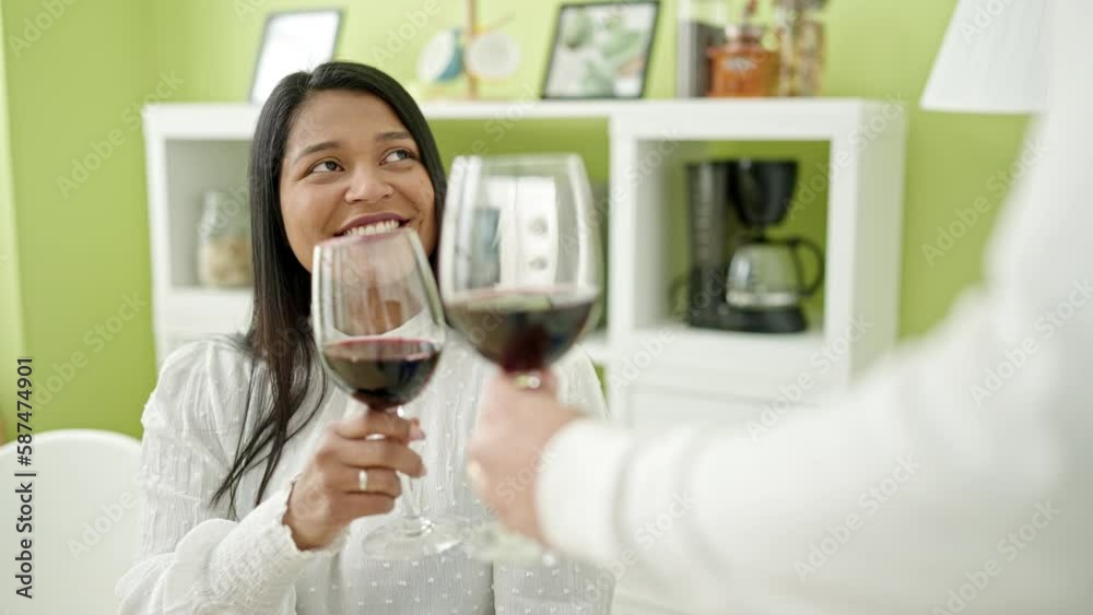 Man and woman couple smiling confident drinking wine at home