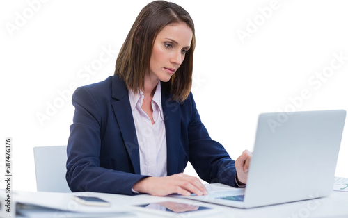 Focused businesswoman using laptop while sitting over white background