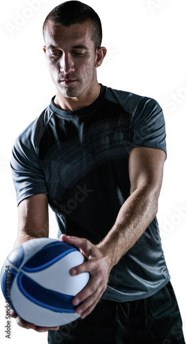 Handsome rugby player holding ball