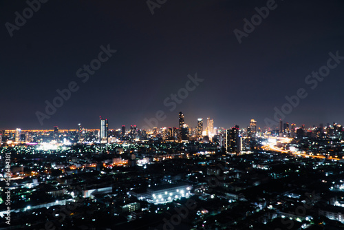 Wallpaper Mural Blur background buildings metropolitan condo high street road blurry bokeh light nightlife dark sky night. Defocused blurred thailand Bangkok landscape building with street way. Business background Torontodigital.ca