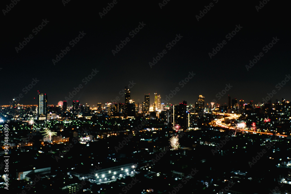 Obraz premium Blur background buildings metropolitan condo high street road blurry bokeh light nightlife dark sky night. Defocused blurred thailand Bangkok landscape building with street way. Business background