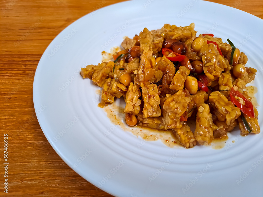 Orek Tempe, stir fry tempeh cooked with sweet soy sauce, peanut and red chili. Indonesian food with sweet and spicy taste Orek Tempe, stir fry tempeh cooked with sweet soy sauce, peanut and red chili. Indonesian food with sweet and spicy taste