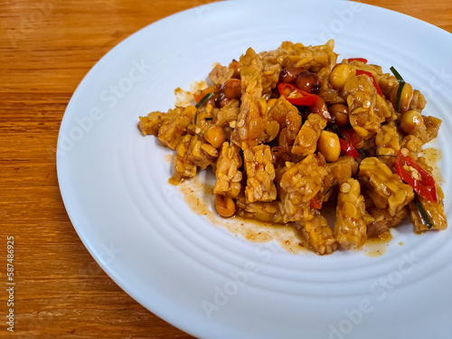 Orek Tempe, stir fry tempeh cooked with sweet soy sauce, peanut and red chili. Indonesian food with sweet and spicy taste