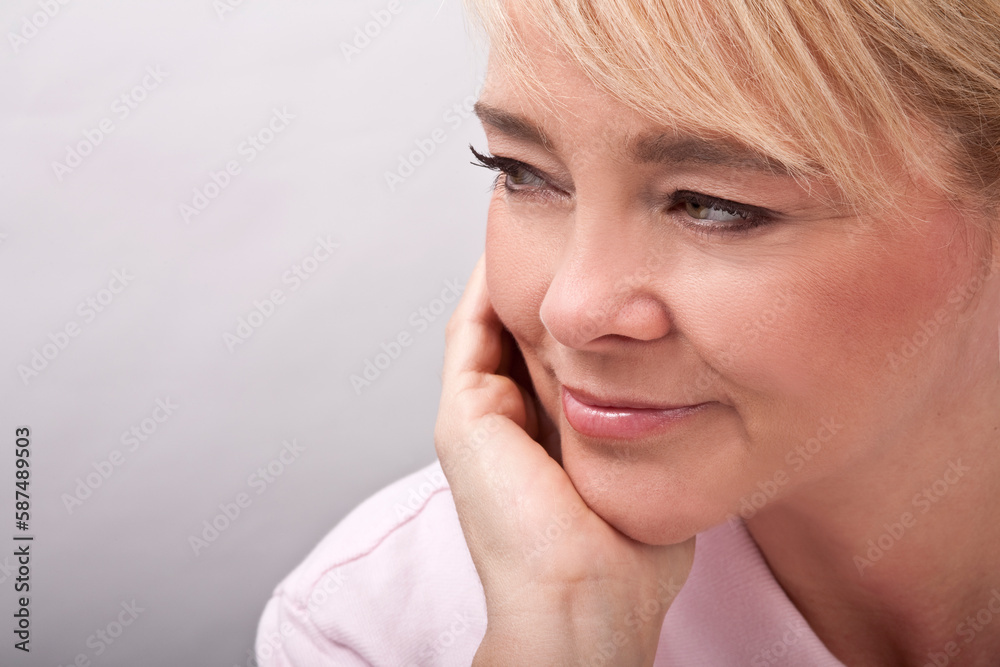 Close up portrait of beautiful mature woman looking away smiling. Close up portrait of beautiful mature woman looking away smiling.