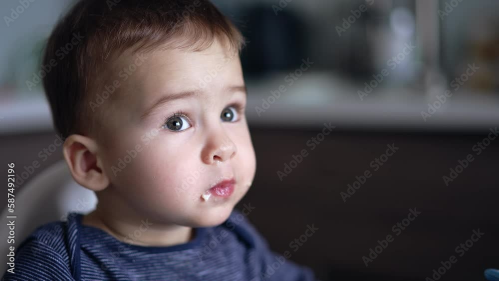 Well-eating toddler close up. Mommy feeding her little toddler. Blurred backdrop. Well-eating toddler close up. Mommy feeding her little toddler. Blurred backdrop.