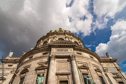 Copenhagen, Denmark - September 13, 2010: fisheye along beige stone south side entrance of Frederiks church up to blue cloudscape. Statues of Nikolaj Edinger Balle and R.DAHL-BRUN photo