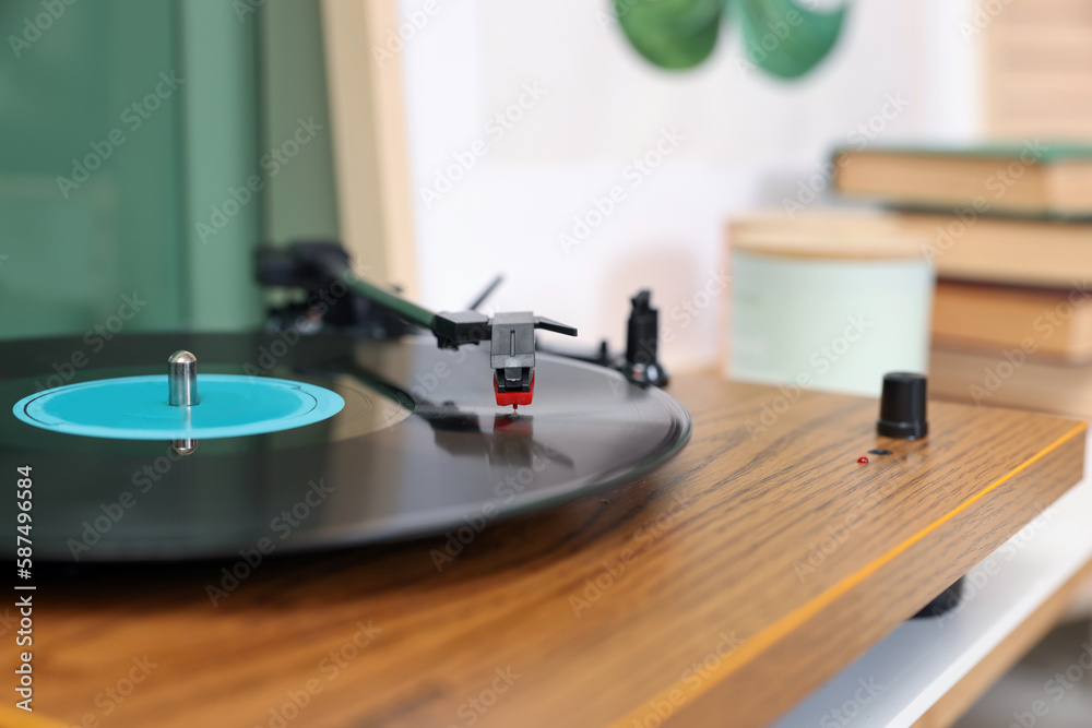 Stylish turntable with vinyl record indoors, closeup. Space for text Stylish turntable with vinyl record indoors, closeup. Space for text