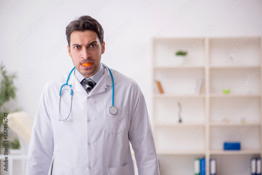 Young male doctor wearing mouthguard Young male doctor wearing mouthguard