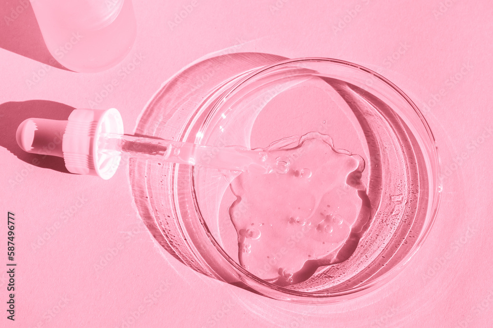 Petri dish. With transparent gel. With a pipette. Cosmetics bottle. On a pink background. Petri dish. With transparent gel. With a pipette. Cosmetics bottle. On a pink background.